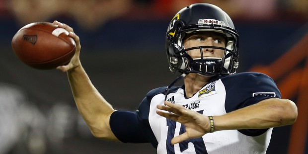 Northern Arizona quarterback Case Cookus warms up for an NCAA college football game against Arizona...
