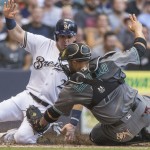Milwaukee Brewers' Scooter Gennett is tagged out by Arizona Diamondbacks' Welington Castillo during the first inning of a baseball game Tuesday, July 26, 2016, in Milwaukee. (AP Photo/Tom Lynn)