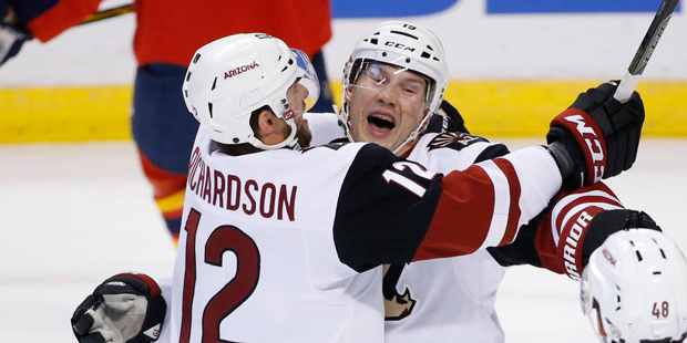 Arizona Coyotes right wing Shane Doan, center, celebrates with right wing Brad Richardson (12) and ...
