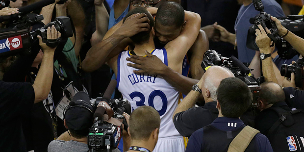 Golden State Warriors guard Stephen Curry (30) hugs Oklahoma City Thunder forward Kevin Durant afte...