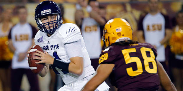 Weber State quarterback Billy Green, left, tries to avoid a sack by Arizona State linebacker Salamo...