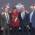 Clayton Keller, seventh overall pick, stands on stage with members of the Arizona Coyotes management team at the NHL hockey draft, Friday, June 24, 2016, in Buffalo, N.Y. (Nathan Denette/The Canadian Press via AP)