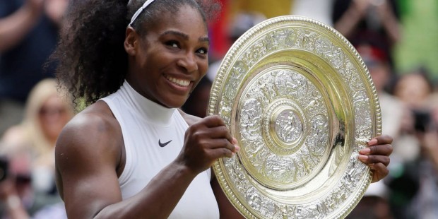 Serena Williams of the U.S holds up the trophy after beating Angelique Kerber of Germany in the wom...