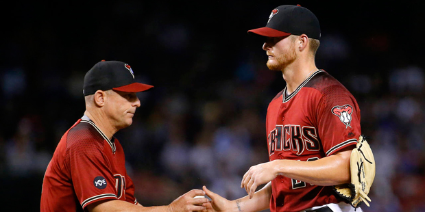 Arizona Diamondbacks pitcher Shelby Miller, right, is removed from the game by manager Chip Hale af...