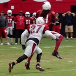 Receiver Larry Fitzgerald goes up for the ball with safety Tyvon Branch in coverage during training camp Aug. 5. (Photo by Adam Green/Arizona Sports)