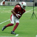 Receiver Larry Fitzgerald turns up field after making a catch during training camp on Aug. 1. (Photo by Adam Green/Arizona Sports)