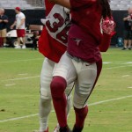 Receiver Larry Fitzgerald and safety D.J. Swearinger go up for the ball during training camp Aug. 5. (Photo by Adam Green/Arizona Sports)