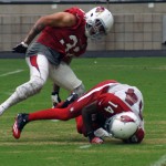 Safety Tyrann Mathieu stands over receiver J.J. Nelson after making a tackle during training camp Aug. 21. (Photo by Adam Green/Arizona Sports)