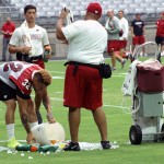 Defensive back Tyrann Mathieu helps clean up after the ice bucket spilled during training camp on Aug. 1. (Photo by Adam Green/Arizona Sports)