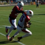 WR Michael Floyd comes down with a catch while S Tony Jefferson is in coverage during a training camp practice Aug. 14. (Photo by Adam Green/Arizona Sports)