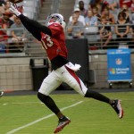 Receiver Jaron Brown reaches out for the ball during training camp Aug. 9. (Photo by Adam Green/Arizona Sports)