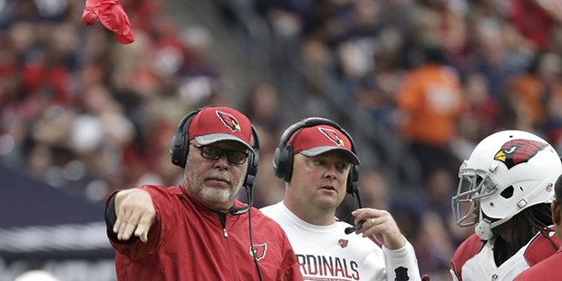 Arizona Cardinals head coach Bruce Arians, left, challenges a call during the first half of an NFL ...