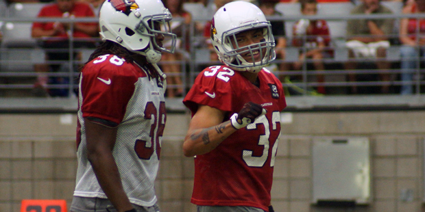 Safety Tyrann Mathieu smiles while walking with RB Andre Ellington during training camp Aug. 21. (P...