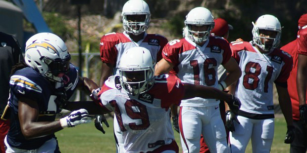 Cardinals receiver Chris Hubert works against Chargers defensive back Larry Scott during a training...