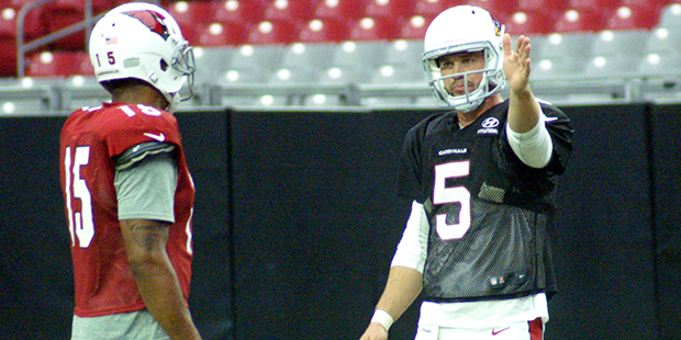 QB Drew Stanton directs receiver Michael Floyd during training camp Aug. 2. (Photo by Adam Green/Ar...
