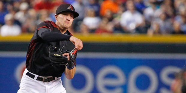 Arizona Diamondbacks' Nick Ahmed, left, throws to first base after forcing out Los Angeles Dodgers'...