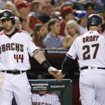 Arizona Diamondbacks' Brandon Drury (27) shakes hands with Paul Goldschmidt (44) after Drury scored a run against the New York Mets during the fifth inning of a baseball game Monday, Aug. 15, 2016, in Phoenix. (AP Photo/Ross D. Franklin)