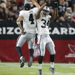 Oakland Raiders running back George Atkinson (34) celebrates with Derek Carr after scoring a touchdown in the second half of an NFL preseason football game against the Arizona Cardinals, Friday, Aug. 12, 2016, in Glendale, Ariz. (AP Photo/Rick Scuteri)