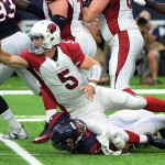 Arizona Cardinals quarterback Drew Stanton (5) throws an incomplete pass as he is hit by Houston Texans linebacker Brennan Scarlett, bottom, during the first half of an NFL preseason football game, Sunday, Aug. 28, 2016, in Houston. (AP Photo/George Bridges)