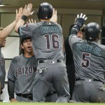 Arizona Diamondbacks' Chris Owings and Rickie Weeks are congratulated after scoring against the San Diego Padres in the eighth inning of a baseball game Friday, Aug. 19, 2016, in San Diego. (AP Photo/Lenny Ignelzi)