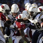 San Diego Chargers running back Melvin Gordon, right, runs the ball while under pressure from Arizona Cardinals outside linebacker Markus Golden during the first half of a preseason NFL football game, Friday, Aug. 19, 2016, in San Diego. (AP Photo/Denis Poroy)