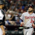 Washington Nationals Bryce Harper (34) scores in the fifth inning on a double by Daniel Murphy during a baseball game against the Arizona Diamondbacks, Monday, Aug. 1, 2016, in Phoenix. (AP Photo/Rick Scuteri)