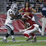 Oakland Raiders running back George Atkinson III (34) pushes aside Arizona Cardinals defensive back Marqui Christian on a touchdown run during the second half of an NFL preseason football game, Friday, Aug. 12, 2016, in Glendale, Ariz. (AP Photo/Ralph Freso)