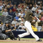 San Diego Padres' Nick Noonan drives a sacrifice fly against the Arizona Diamondbacks in the seventh inning of a baseball game Friday, Aug. 19, 2016, in San Diego. (AP Photo/Lenny Ignelzi)