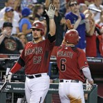 Arizona Diamondbacks' David Peralta (6) celebrates his run scored against the Washington Nationals with Zack Godley (52) during the fifth inning of a baseball game Wednesday, Aug. 3, 2016, in Phoenix. (AP Photo/Ross D. Franklin)