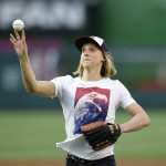 Olympic gold-medal swimmer Katie Ledecky throws out the ceremonial first pitch before a baseball game between the Baltimore Orioles and the Washington Nationals, Wednesday, Aug. 24, 2016, in Washington. (AP Photo/Nick Wass)