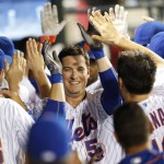 New York Mets Kelly Johnson, center, is congratulated in the dugout after he hit a game-tying, two-run, home run during the ninth inning of a baseball game against the Arizona Diamondbacks, Wednesday, Aug. 10, 2016, in New York. (AP Photo/Kathy Willens)