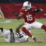 
              Arizona Cardinals' Michael Floyd (15) gets pulled down by Oakland Raiders' David Amerson (29) after a long pass reception during the first half of an NFL preseason football game Friday, Aug. 12, 2016, in Glendale, Ariz. (AP Photo/Ross D. Franklin)
            