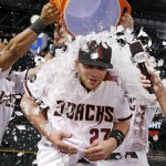 Arizona Diamondbacks' Brandon Drury (27) gets a bucket of ice dumped on him by Yasmany Tomas, left, and Chris Owings, back right, after Drury's game-winning sacrifice fly against the against the Atlanta Braves after a baseball game Wednesday, Aug. 24, 2016, in Phoenix. The Diamondbacks defeated the Braves 10-9 in 11 innings. (AP Photo/Ross D. Franklin)