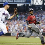 New York Mets third baseman T.J. Rivera, left, chases Arizona Diamondbacks Jean Segura between third and home during the first inning of a baseball game Wednesday, Aug. 10, 2016, in New York. Segura was caught off third, and tried to steal home. (AP Photo/Kathy Willens)