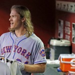 New York Mets' Noah Syndergaard smiles in the dugout after his two-run home run against the Arizona Diamondbacks during the fifth inning of a baseball game, Tuesday, Aug. 16, 2016, in Phoenix. (AP Photo/Ross D. Franklin)