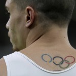 The Olympic rings are seen tattooed on the back of Greece's gymnast Eleftherios Petrounias during the artistic gymnastics men's qualification at the 2016 Summer Olympics in Rio de Janeiro, Brazil, Saturday, Aug. 6, 2016. (AP Photo/Dmitri Lovetsky)