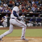 Atlanta Braves' Freddie Freeman follows through on his swing as he connects for a run-scoring single against the Arizona Diamondbacks during the third inning of a baseball game Thursday, Aug. 25, 2016, in Phoenix. (AP Photo/Ross D. Franklin)