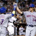 New York Mets' Noah Syndergaard (34) celebrates his two-run home run against the Arizona Diamondbacks with Jose Reyes (7) during the fifth inning of a baseball game, Tuesday, Aug. 16, 2016, in Phoenix. (AP Photo/Ross D. Franklin)