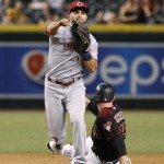 Cincinnati Reds second baseman Jose Peraza, left, throws to first over Arizona Diamondbacks' Phil Gosselin to complete a double play on a ball hit by Diamondbacks' Yasmany Tomas during the seventh inning of a baseball game, Saturday, Aug. 27, 2016, in Phoenix. (AP Photo/Ralph Freso)