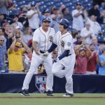 San Diego Padres' Patrick Kivlehan, right, is congratulated by third base coach Glenn Hoffman after hitting a home run during the fifth inning of a baseball game against the Arizona Diamondbacks, Saturday, Aug. 20, 2016, in San Diego. The home run by Patrick Kivlehan was his first Major League hit. (AP Photo/Don Boomer)