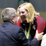 Virginia Thrasher, right, of the United States receives the gold medal from International Olympic Committee President Thomas Bach during the award ceremony for the Women's 10 Air Rifle competition9at Olympic Shooting Center at the 2016 Summer Olympics in Rio de Janeiro, Brazil, Saturday, Aug. 6, 2016. (AP Photo/Eugene Hoshiko)