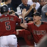 Arizona Diamondbacks' Rickie Weeks (5) celebrates his run scored against the Milwaukee Brewers with manager Chip Hale, right, during the fourth inning of a baseball game Sunday, Aug. 7, 2016, in Phoenix. (AP Photo/Ross D. Franklin)