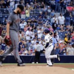 Arizona Diamondbacks starting pitcher Robbie Ray walks back to the mound after giving up a home run to San Diego Padres' Patrick Kivlehan, right, during the fifth inning of a baseball game, Saturday, Aug. 20, 2016, in San Diego. The home run by Patrick Kivlehan was his first Major League hit. (AP Photo/Don Boomer)