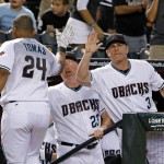 Arizona Diamondbacks' Yasmany Tomas (24) celebrates his home run against the Milwaukee Brewers with manager Chip Hale (3) and pitching coach Mike Butcher (23) during the second inning of a baseball game Friday, Aug. 5, 2016, in Phoenix. (AP Photo/Ross D. Franklin)