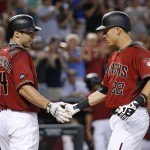 Arizona Diamondbacks' Jake Lamb (22) shakes hands with Paul Goldschmidt (44) after connecting for a two-run home run against the Milwaukee Brewers during the fifth inning of a baseball game Sunday, Aug. 7, 2016, in Phoenix. (AP Photo/Ross D. Franklin)