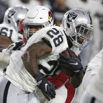 
              Oakland Raiders running back Latavius Murray (28) looks for running room against the Arizona Cardinals during the first half of an NFL preseason football game Friday, Aug. 12, 2016, in Glendale, Ariz. (AP Photo/Ross D. Franklin)
            