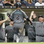 Arizona Diamondbacks' Jean Segura is congratulated returning to the dugout after scoring on a throwing error by the San Diego Padres in the seventh inning of a baseball game Friday, Aug. 19, 2016, in San Diego. (AP Photo/Lenny Ignelzi)