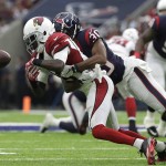 Arizona Cardinals wide receiver J.J. Nelson (14) can't hang on to a pass as he is hit by Houston Texans cornerback Kevin Johnson (30) during the first half of an NFL preseason football game, Sunday, Aug. 28, 2016, in Houston. (AP Photo/JR)