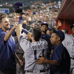 Milwaukee Brewers' Hernan Perez (14) celebrates his run scored against the Arizona Diamondbacks with teammates in the dugout during the fourth inning of a baseball game Friday, Aug. 5, 2016, in Phoenix. (AP Photo/Ross D. Franklin)