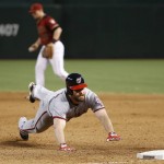 Washington Nationals' Daniel Murphy, right, dives safely back into first base after an infield hit that Arizona Diamondbacks' Brandon Drury, back left, could not make a play on during the ninth inning of a baseball game Wednesday, Aug. 3, 2016, in Phoenix. The Nationals defeated the Diamondbacks 8-3. (AP Photo/Ross D. Franklin)